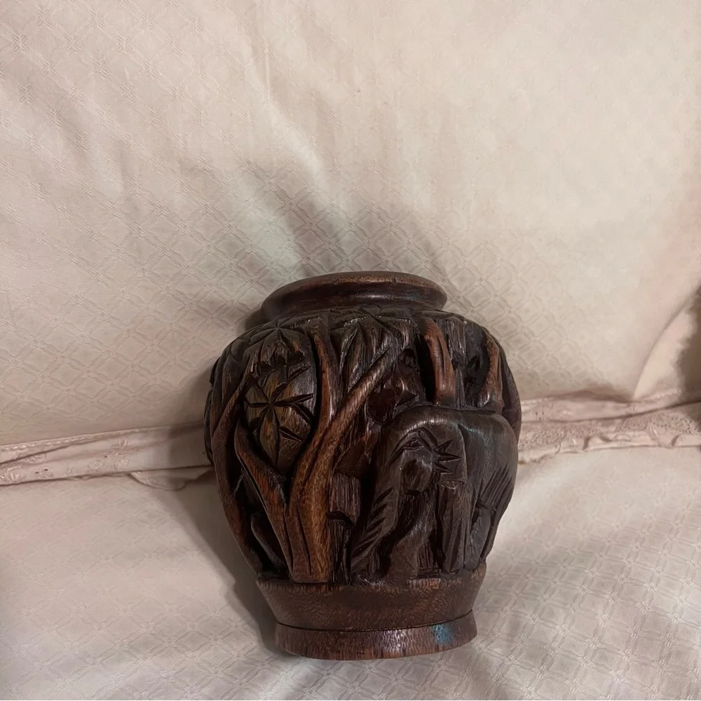 Carved wooden type vase with elephant. Approximately 6 inches high.